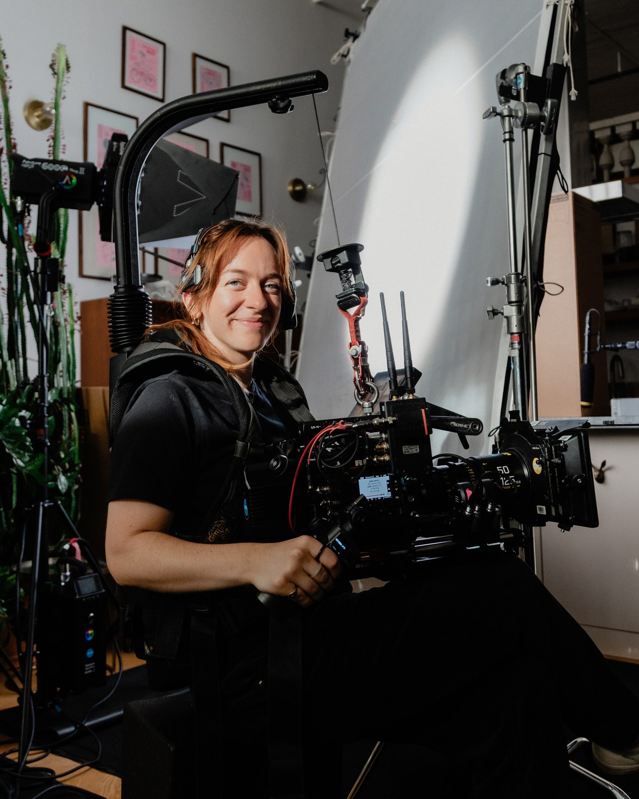 Behind the scenes: a smiling camera operator with the camera rig on the Book Outlet set