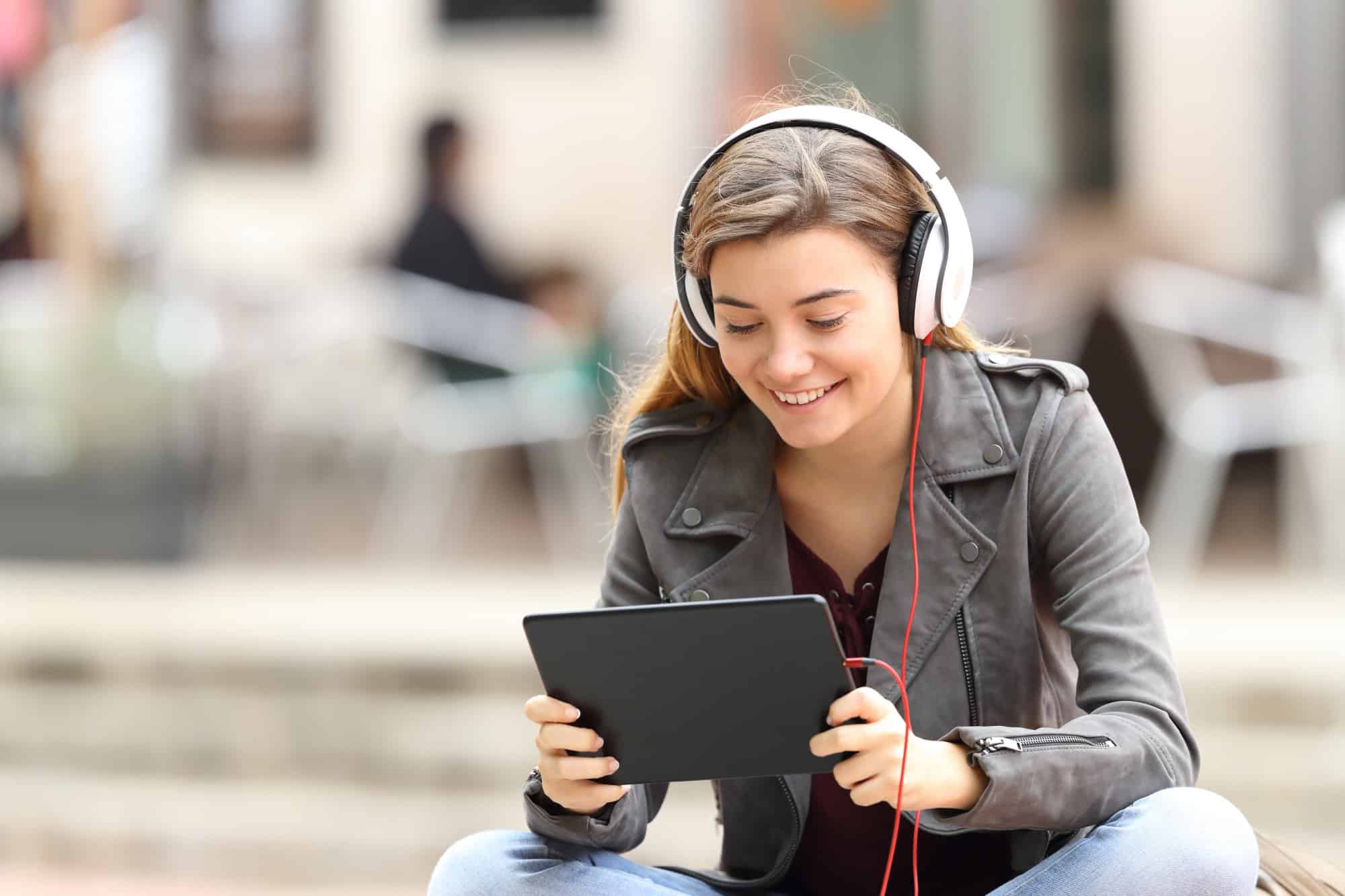 Girl learning on line with a tablet and headphones