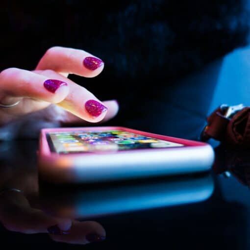 A lady hand pressing an iPhone