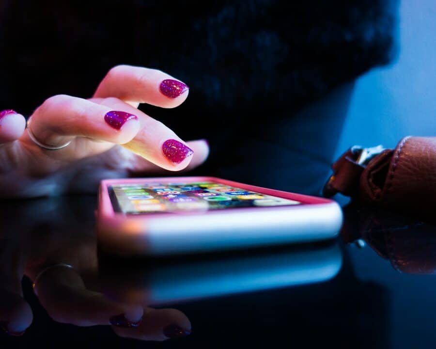 A lady hand pressing an iPhone